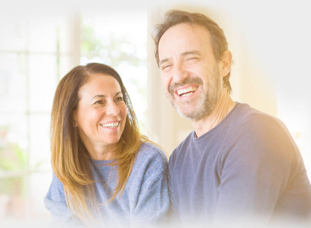 Middle-aged couple smiling after receiving HST rebate in Ontario