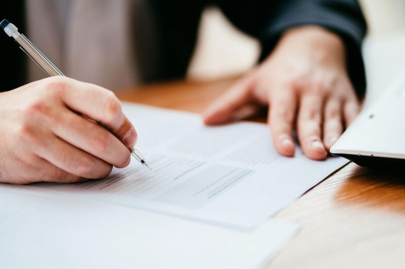 Previous property owner signing assignment agreement contract